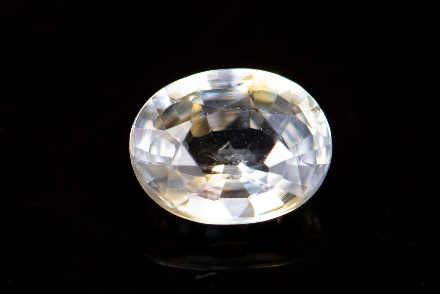Light yellow sapphire 0.60ct VS oval cut orange fluorescence