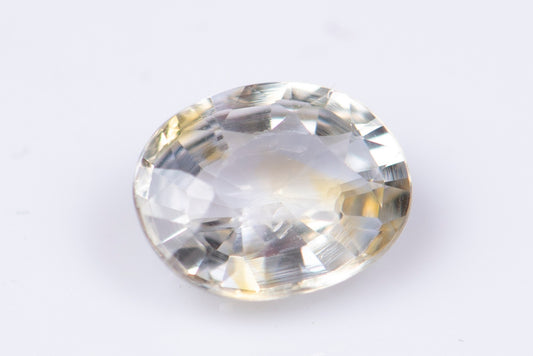 Light yellow sapphire 0.60ct VS oval cut orange fluorescence