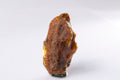 Natural Baltic amber rough 15.6g standing upright, weathered brown crust over golden amber