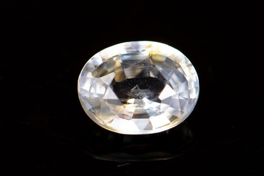 Light yellow sapphire 0.60ct VS oval cut orange fluorescence