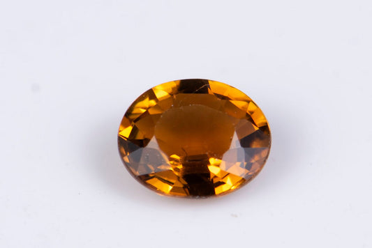 Orange tourmaline dravite 0.45ct fluorescent oval cut